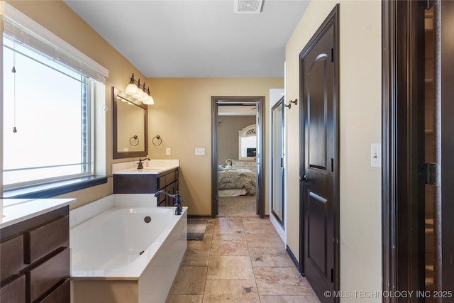 bathroom with a stall shower, visible vents, ensuite bathroom, a garden tub, and vanity