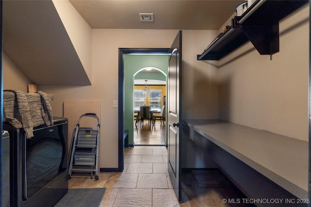 laundry area with washer / clothes dryer, visible vents, and baseboards