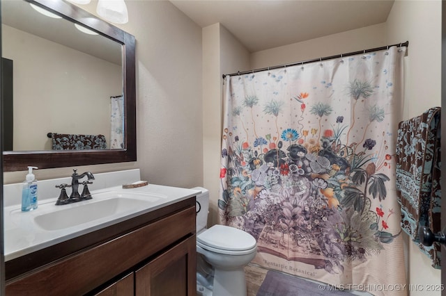 bathroom featuring toilet and vanity