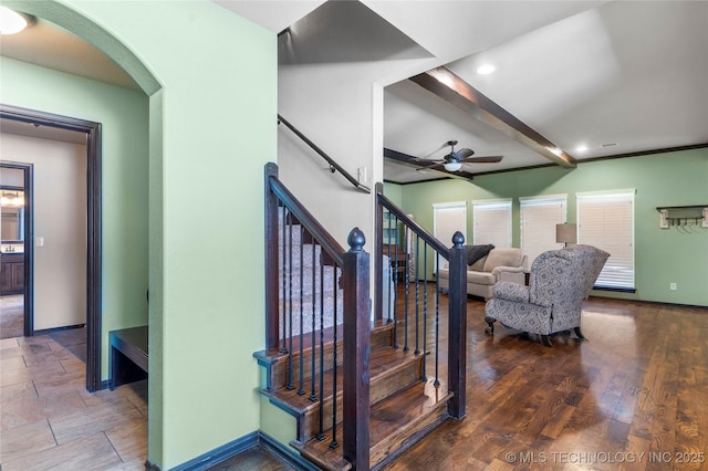 staircase with a ceiling fan, baseboards, beamed ceiling, and wood finished floors