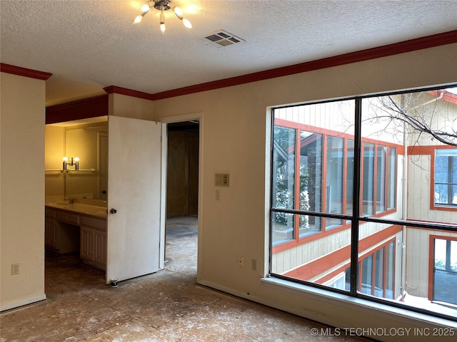 unfurnished bedroom with ornamental molding, visible vents, and a textured ceiling