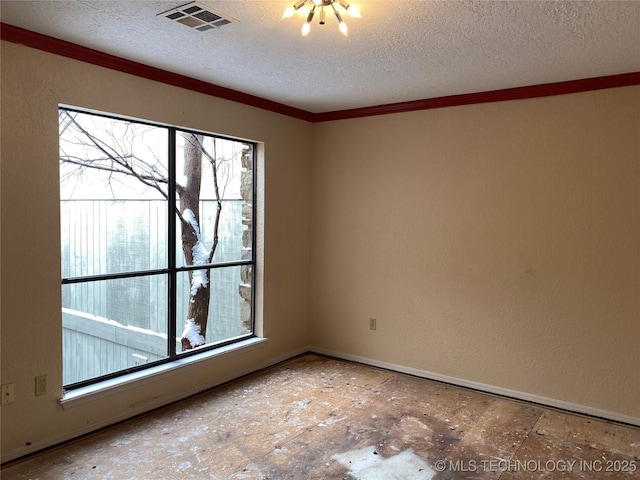 empty room with a textured ceiling, visible vents, and crown molding