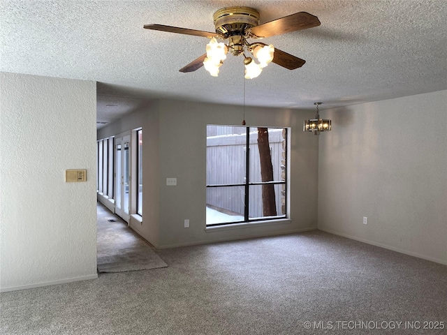 unfurnished room with carpet, a textured wall, a textured ceiling, and baseboards