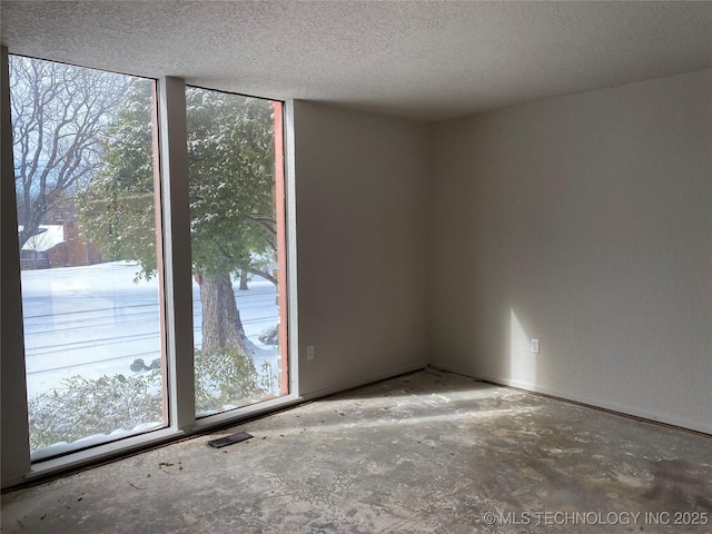 spare room with a textured ceiling and visible vents