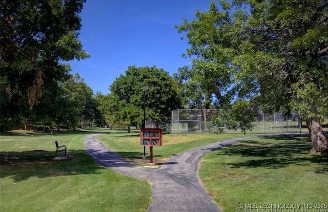 view of home's community featuring fence