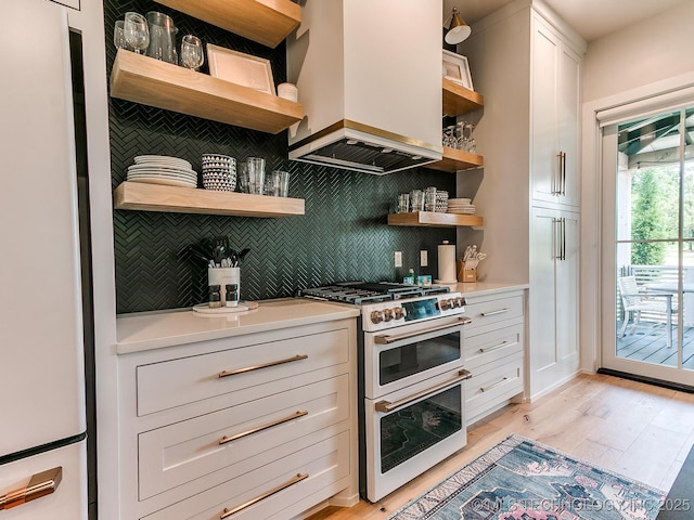 kitchen with premium range hood, open shelves, white appliances, and light countertops