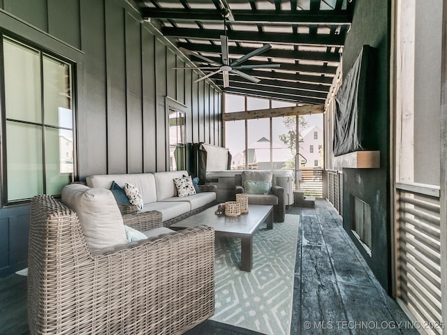 sunroom with a ceiling fan and lofted ceiling with beams