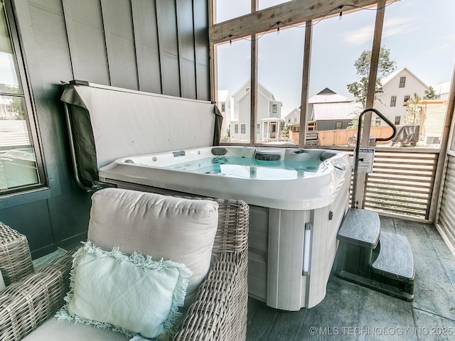 interior space with a hot tub and wood finished floors