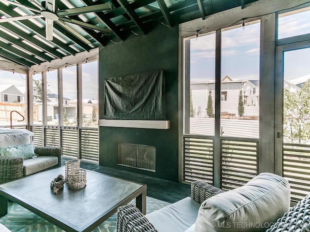 interior space with a large fireplace, lofted ceiling, and a wealth of natural light