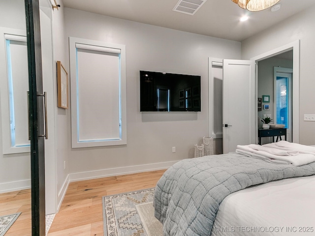 bedroom with light wood-style floors, recessed lighting, visible vents, and baseboards