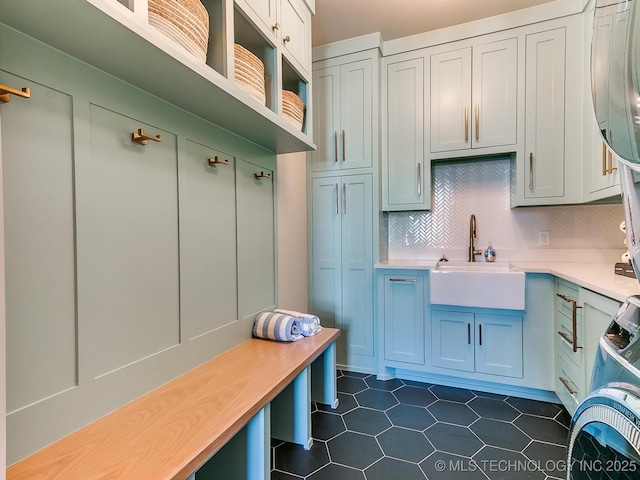 mudroom featuring a sink and dark tile patterned floors