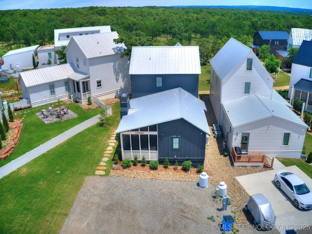 drone / aerial view with a wooded view