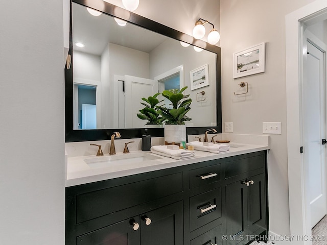 full bathroom with double vanity and a sink