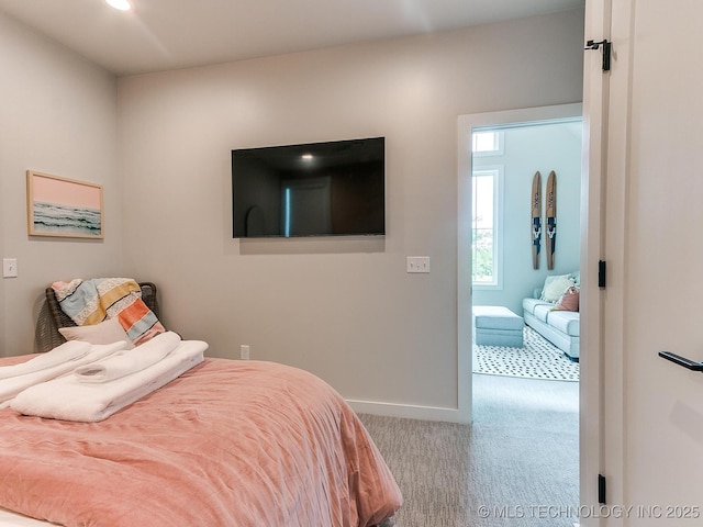 bedroom featuring baseboards and carpet flooring