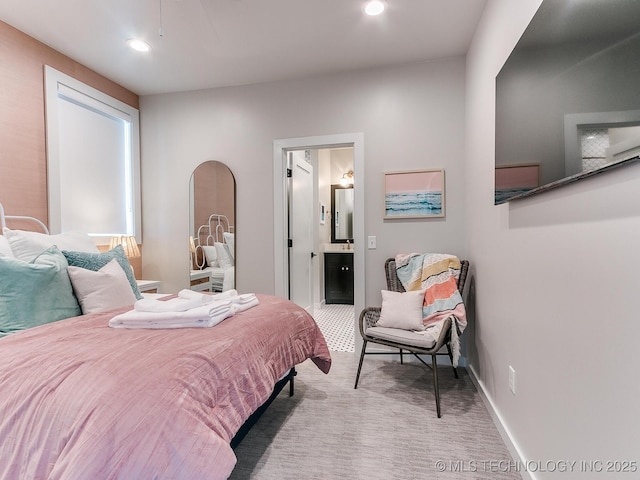 carpeted bedroom with baseboards, connected bathroom, and recessed lighting