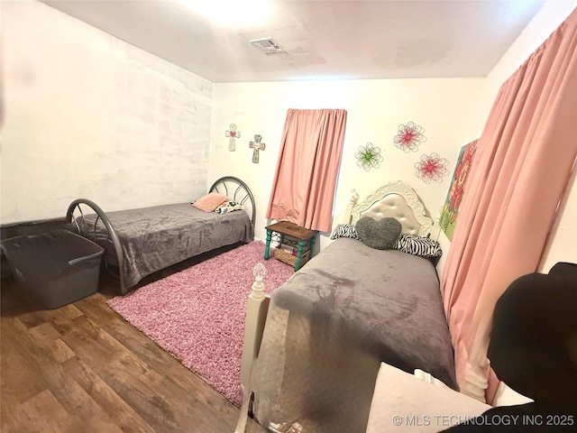 bedroom featuring dark wood-type flooring and visible vents