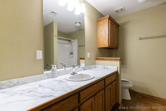 full bath featuring toilet, visible vents, a shower, and vanity