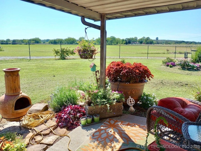 view of yard featuring a rural view and fence