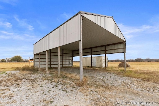 view of pole building with a rural view