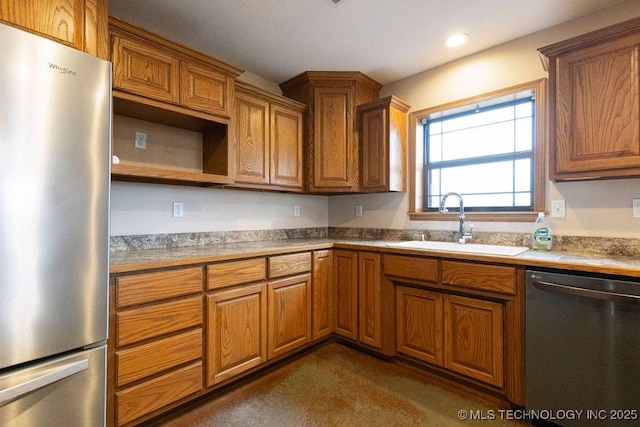 kitchen with light countertops, brown cabinetry, freestanding refrigerator, a sink, and dishwashing machine