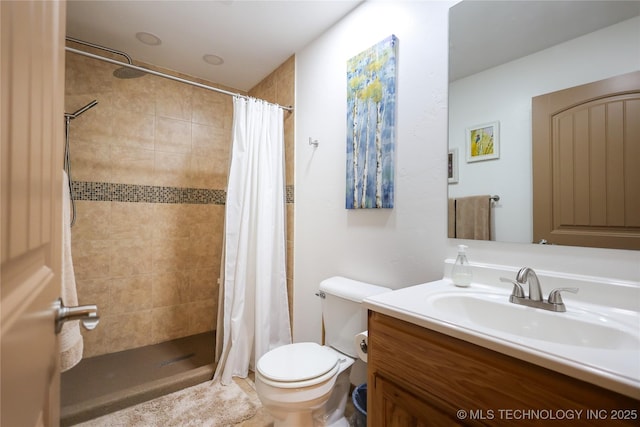 full bathroom with vanity, a shower stall, and toilet