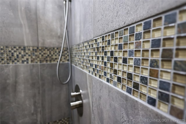 interior details featuring a tile shower