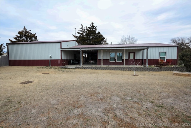 view of front of home featuring a front lawn and metal roof