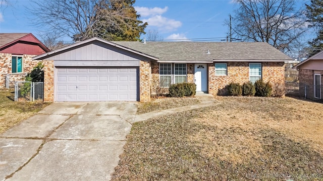 ranch-style house with brick siding, driveway, an attached garage, and fence