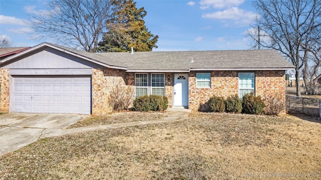 ranch-style house featuring brick siding, a shingled roof, concrete driveway, an attached garage, and a front lawn