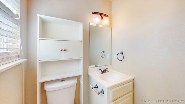 bathroom featuring vanity and toilet