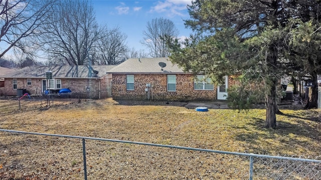 view of front of property with brick siding and fence