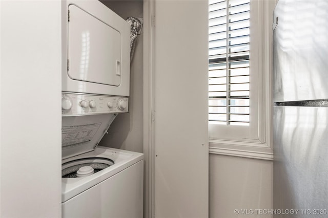 laundry room with laundry area and stacked washer / dryer