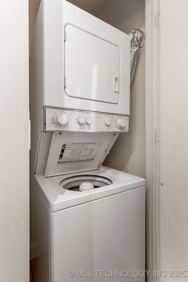 clothes washing area with laundry area and stacked washer and clothes dryer