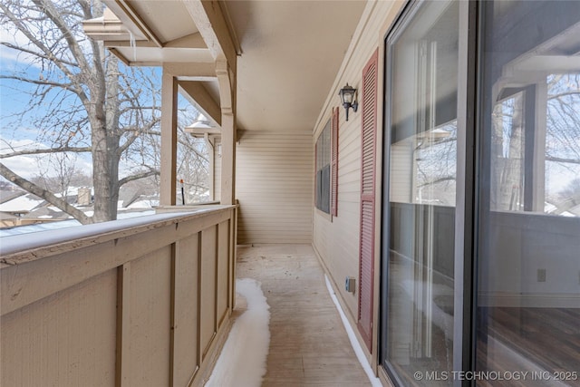 view of snow covered back of property