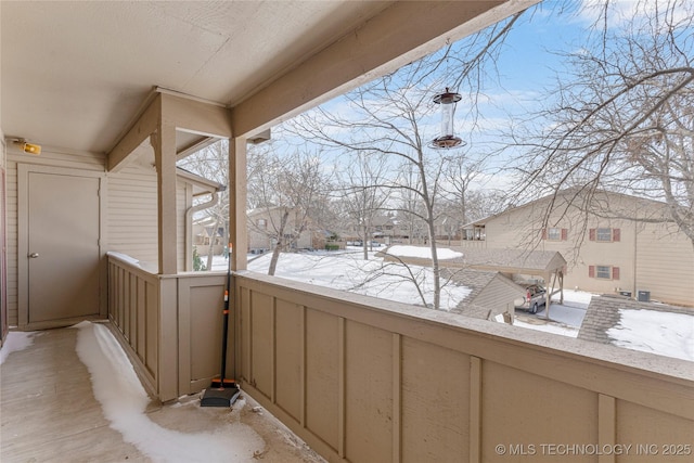 view of snow covered back of property