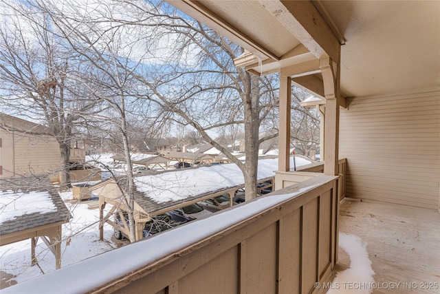 view of snow covered back of property