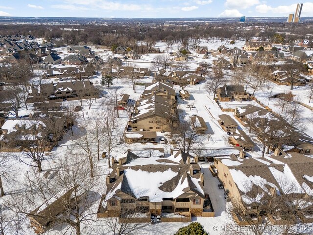 snowy aerial view featuring a residential view