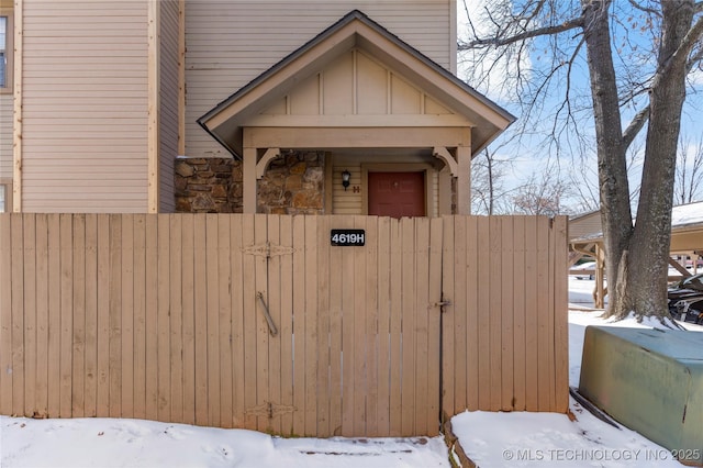 view of front of home featuring board and batten siding and fence