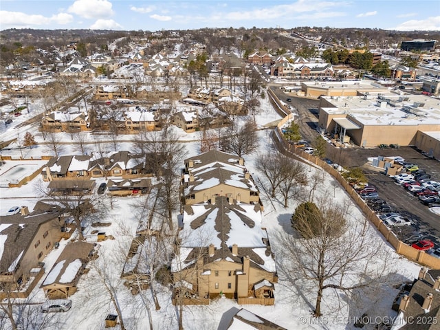 snowy aerial view featuring a residential view