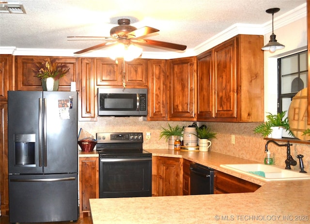 kitchen featuring black appliances, light countertops, and a sink