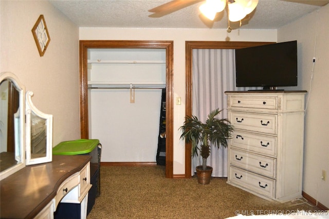 bedroom featuring baseboards, a ceiling fan, dark colored carpet, and a textured ceiling