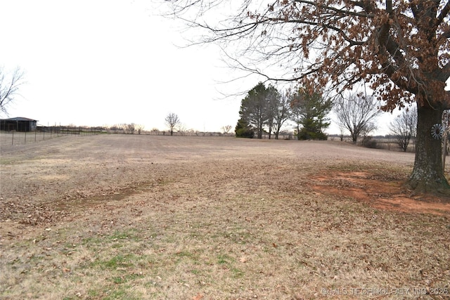 view of yard with a rural view and fence