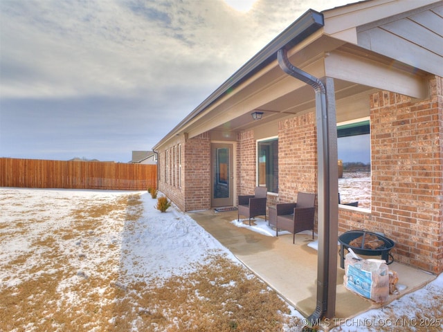 snow covered patio with fence