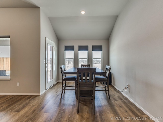 dining area featuring baseboards, vaulted ceiling, and dark wood-style flooring