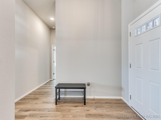 foyer entrance with light wood-type flooring and baseboards