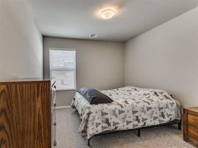 carpeted bedroom featuring visible vents and baseboards