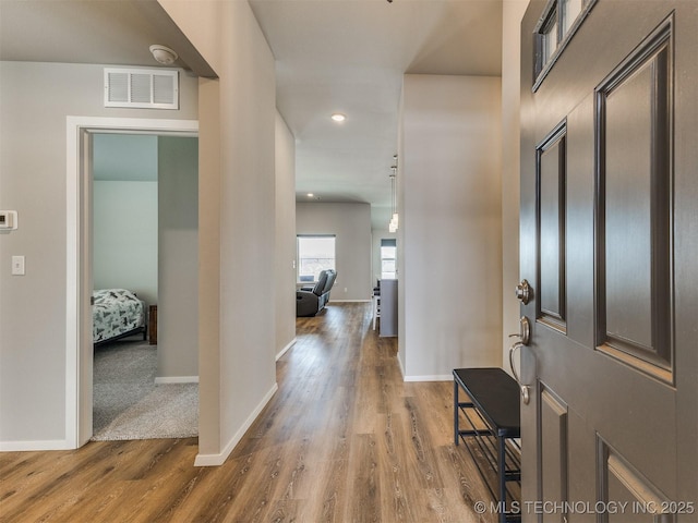 entrance foyer featuring dark wood-style flooring, recessed lighting, visible vents, and baseboards