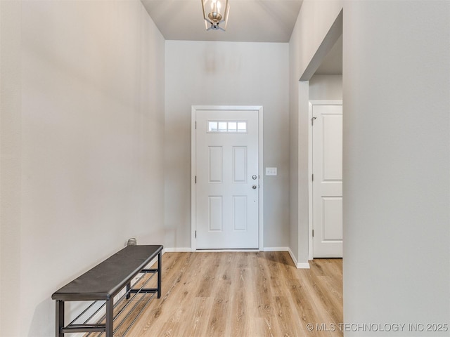 foyer entrance with light wood-type flooring and baseboards