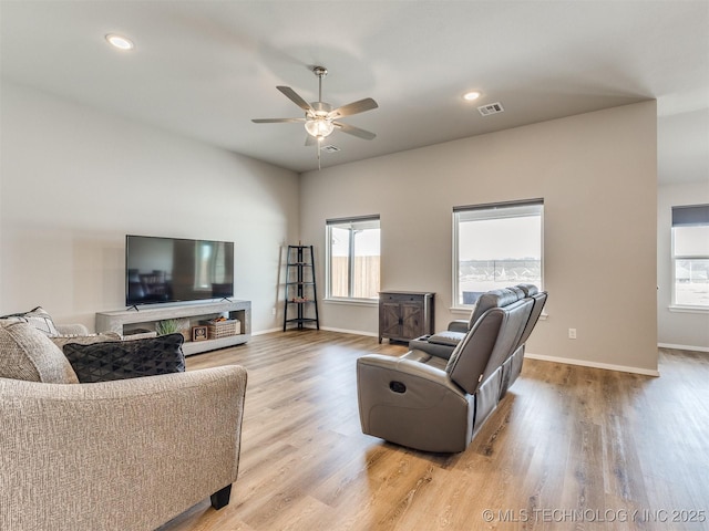 living area with light wood-type flooring, baseboards, visible vents, and recessed lighting