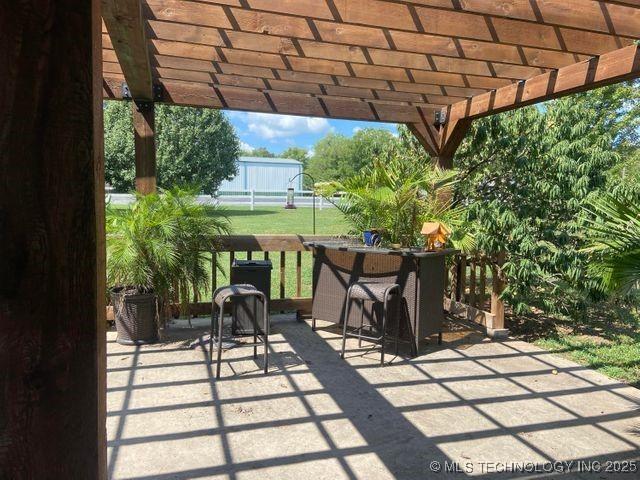 view of patio with fence and a pergola